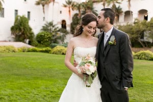 Photo of the bride and groom sneaking a moment after the wedding