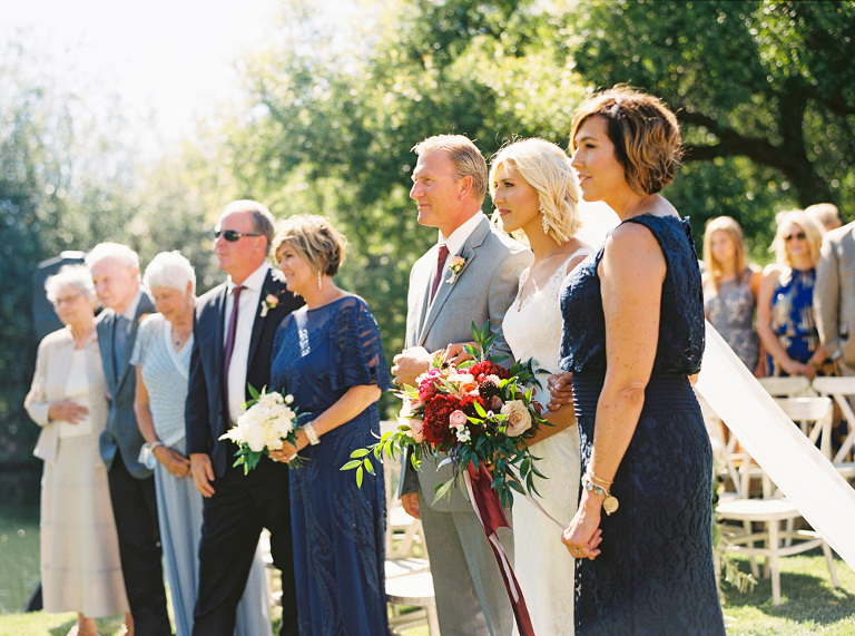 Bride standing with both sets of parents during the ceremony at ggrandv