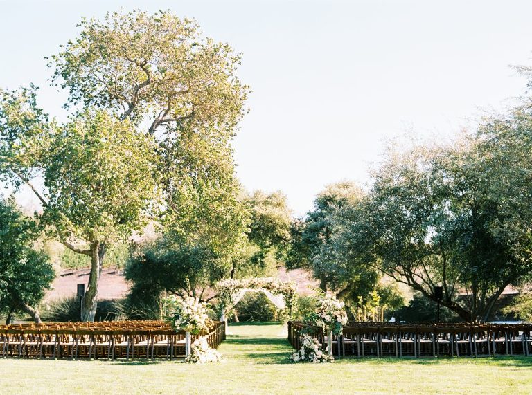 Pond at greengate ranch is ceremony ready with chairs and flowers