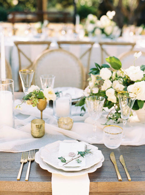 Classic tablescape with white plates and gold silverware