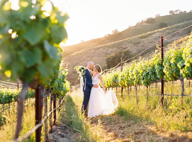 Newlyweds Jack and Aly in the vineyards during sunset at Holman Ranch